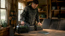 Man comparing portable power stations on workbench