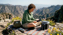 Woman charging devices outdoors on road trip