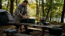 Man setting up camping battery system outdoors